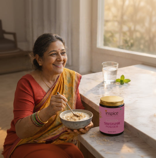 Indian woman in saree enjoying a healthy bowl with Inspice Shatavari Powder on table for women’s wellness