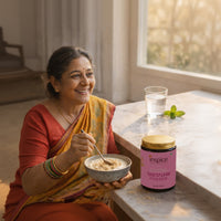 Indian woman in saree enjoying a healthy bowl with Inspice Shatavari Powder on table for women’s wellness